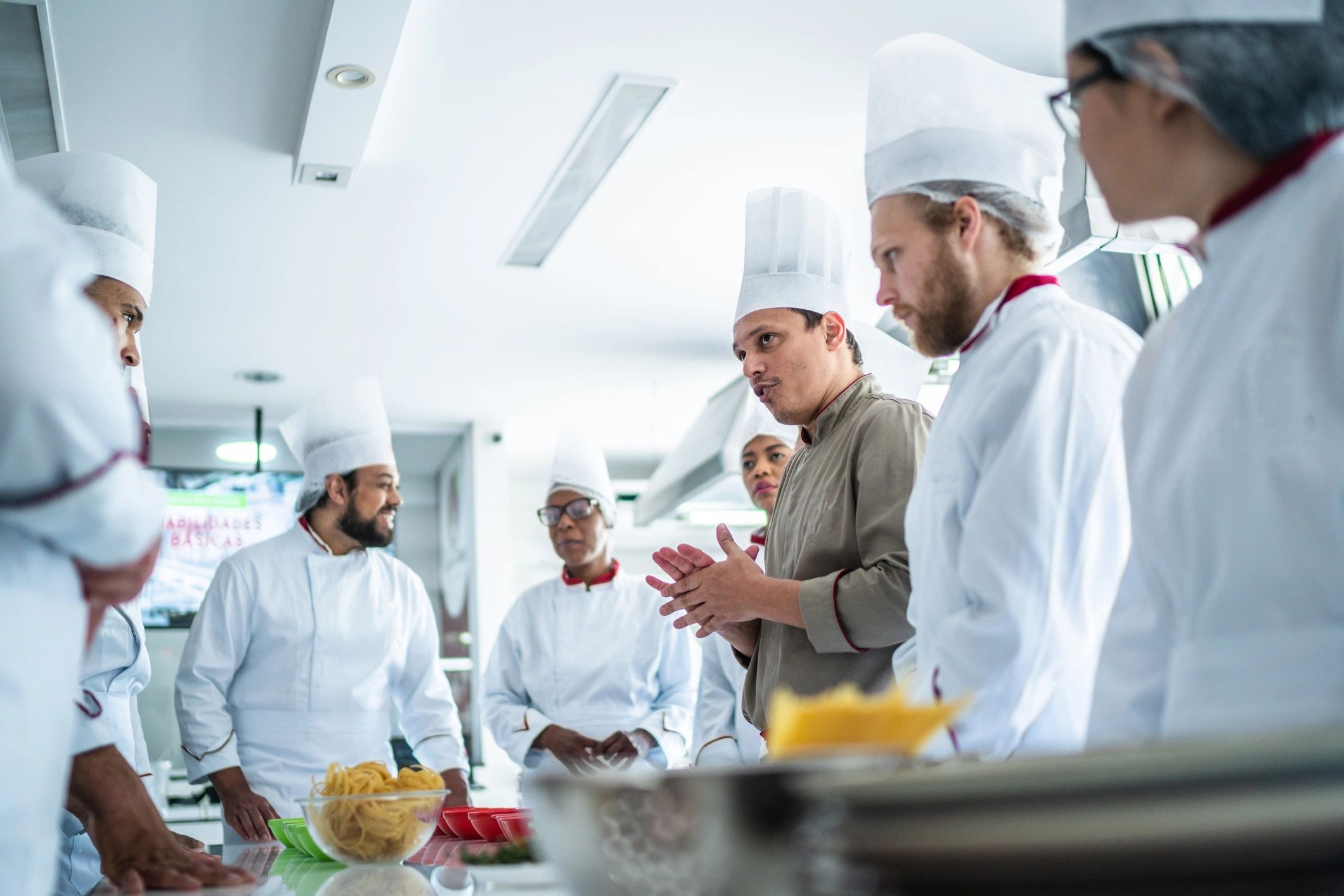 Instructor supporting learners during practical vocational training