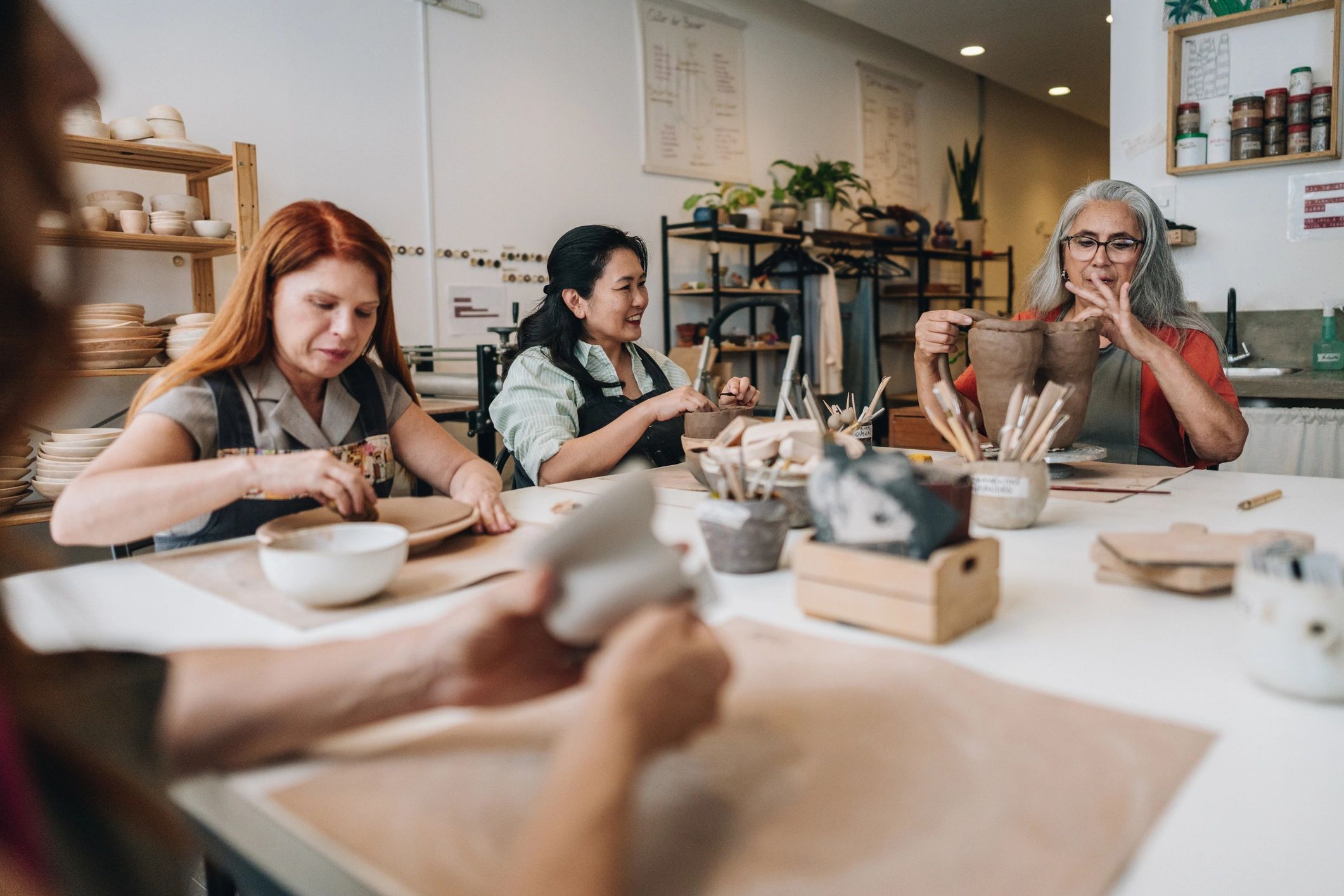 People actively learning practical skills together in an inclusive workshop setting